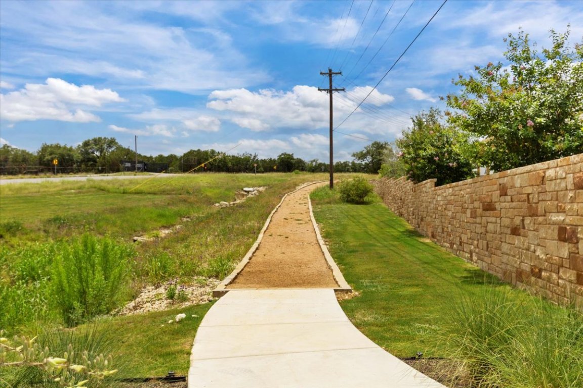 271 Eclipse Drive, Unit 67 Austin, TX 78737 - Photo 34 of 39 a view of a lake with a yard