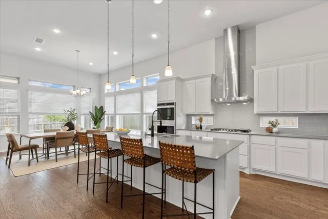 a large kitchen with lots of furniture a sink a dining table and appliances