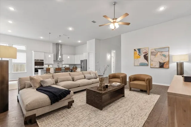 a living room with furniture and kitchen view
