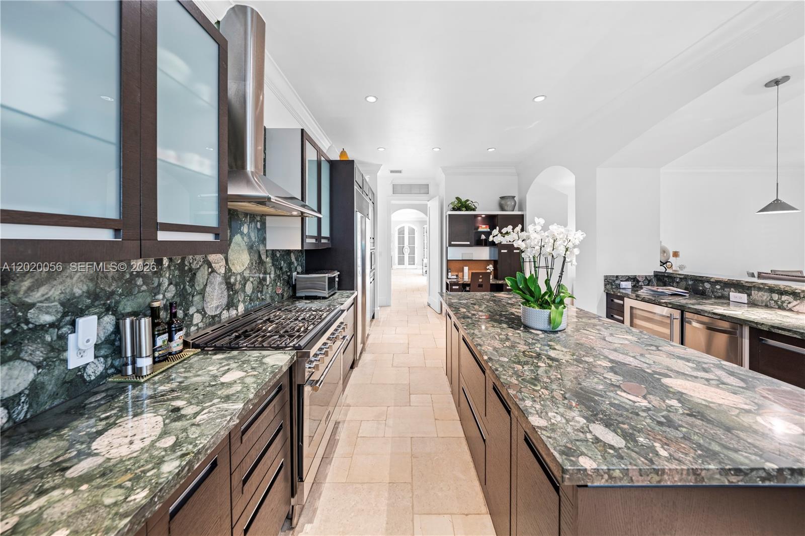 4196 Douglas Road Miami, FL 33133 - Photo 32 of 96 a large kitchen with stainless steel appliances granite countertop a large counter top a stove and a sink