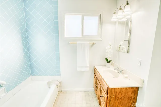 a bathroom with a tub sink and a mirror