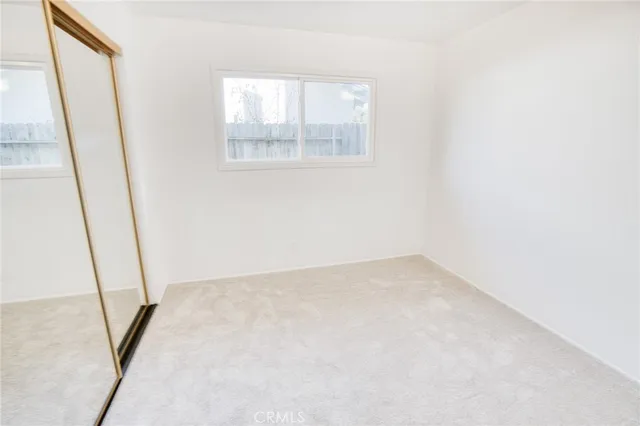 a view of house with backyard and glass windows