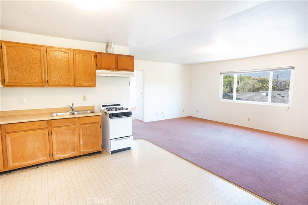 740 Walnut Lane Santa Barbara, CA 93111 - Photo 23 of 28 a kitchen with granite countertop white cabinets and white appliances
