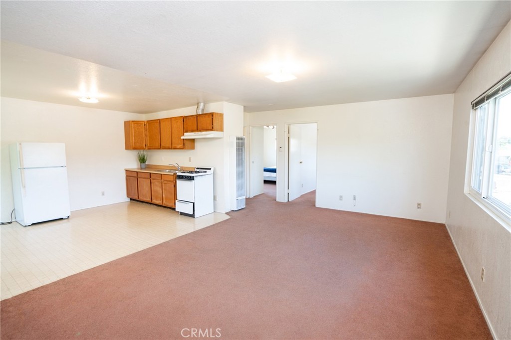 740 Walnut Lane Santa Barbara, CA 93111 - Photo 25 of 28 a view of a kitchen with a sink and a refrigerator
