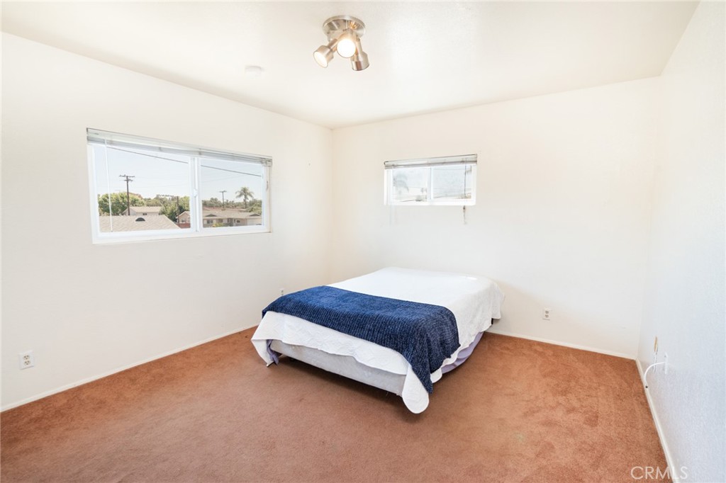 740 Walnut Lane Santa Barbara, CA 93111 - Photo 26 of 28 a spacious bedroom with a bed and a wall painting