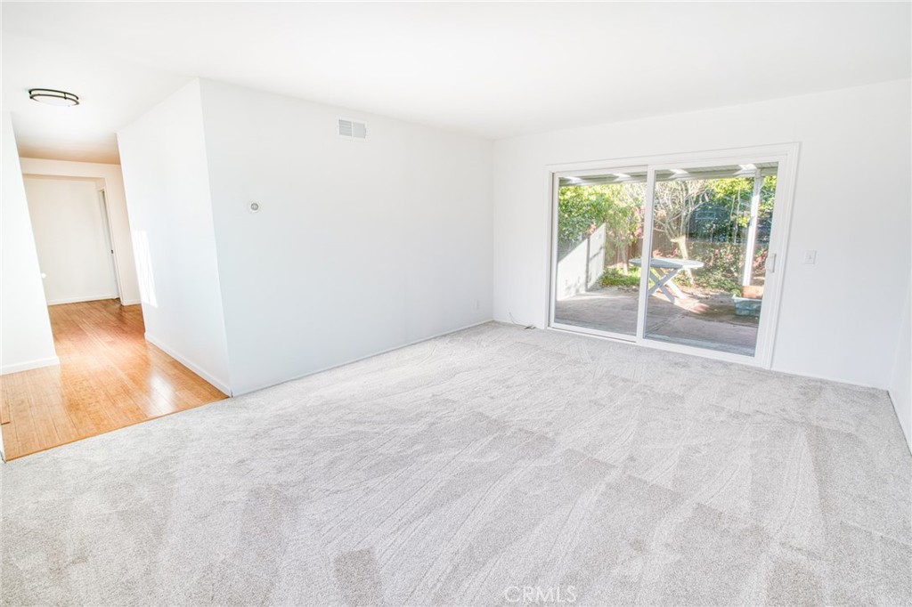 740 Walnut Lane Santa Barbara, CA 93111 - Photo 5 of 28 a view of an empty room with wooden floor and a window