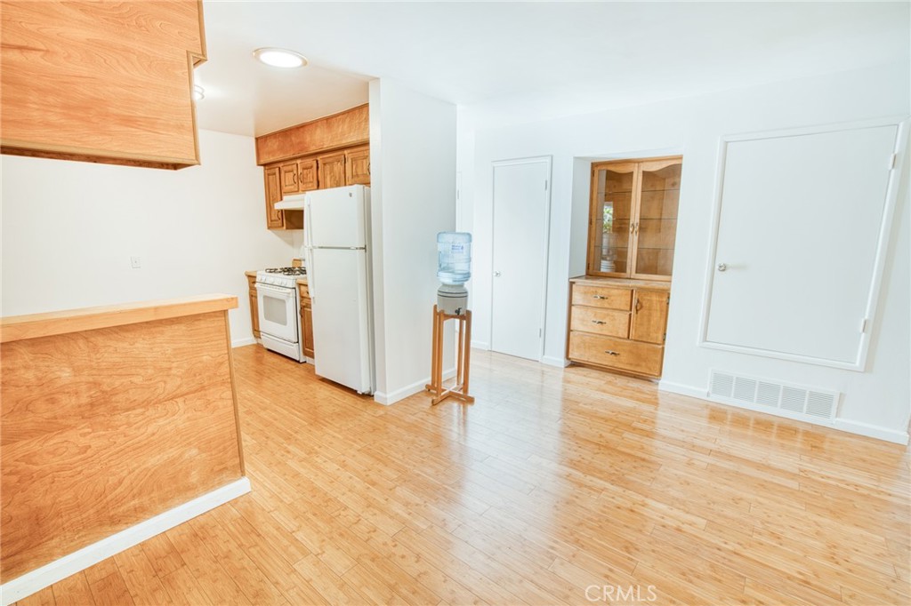 740 Walnut Lane Santa Barbara, CA 93111 - Photo 8 of 28 a view of a livingroom with wooden floor and a refrigerator