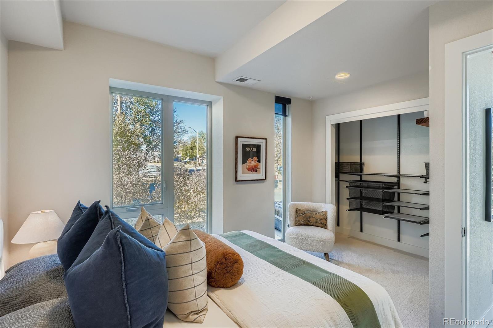 1261 Xavier Street Denver, CO 80204 - Photo 11 of 27 a bedroom with a bed and wooden floor