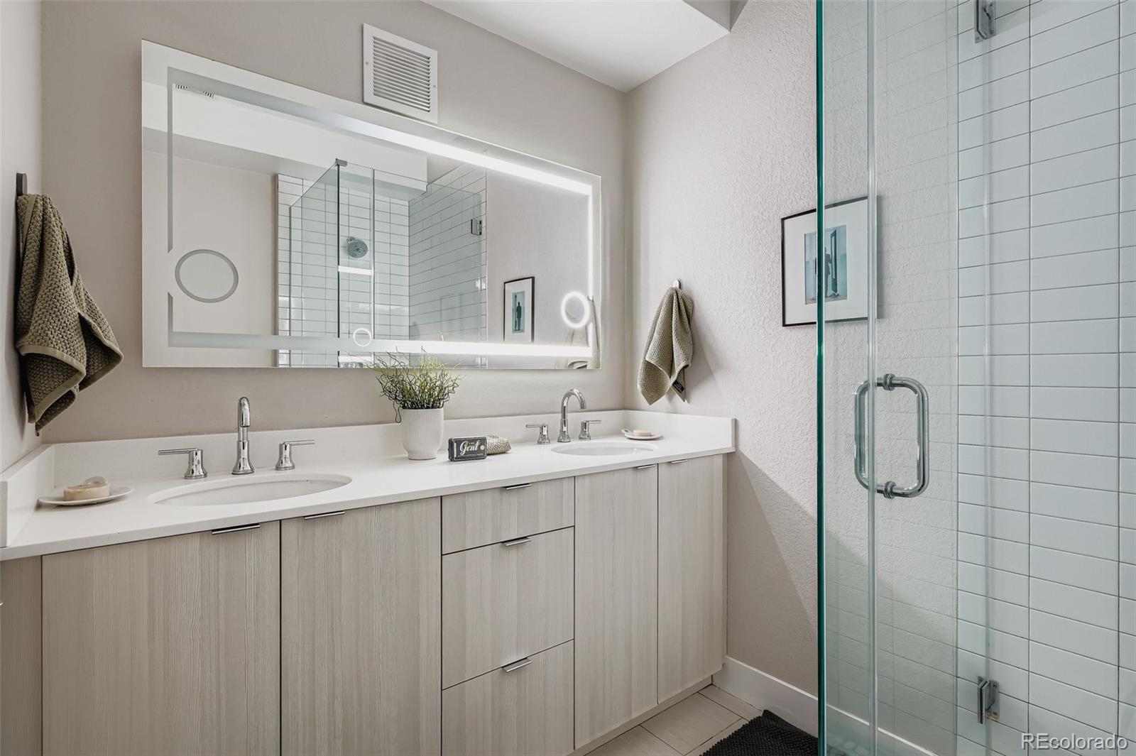 1261 Xavier Street Denver, CO 80204 - Photo 12 of 27 a bathroom with a double vanity sink mirror and double