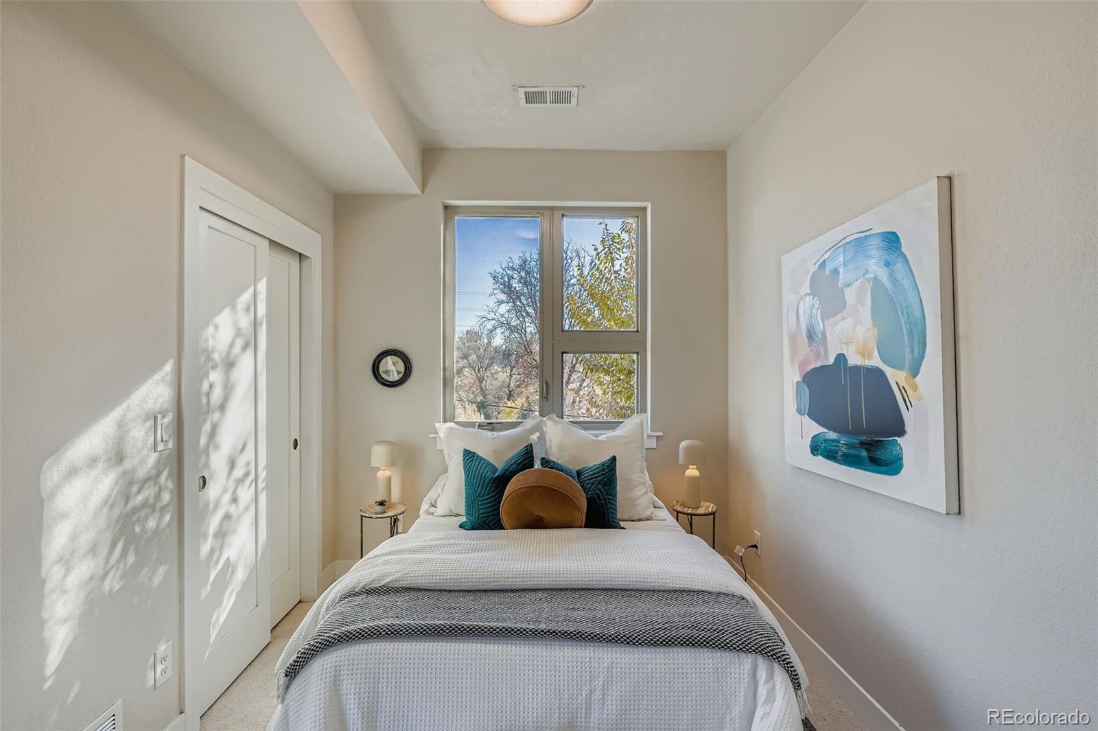1261 Xavier Street Denver, CO 80204 - Photo 13 of 27 a bedroom with a bed and wooden floor