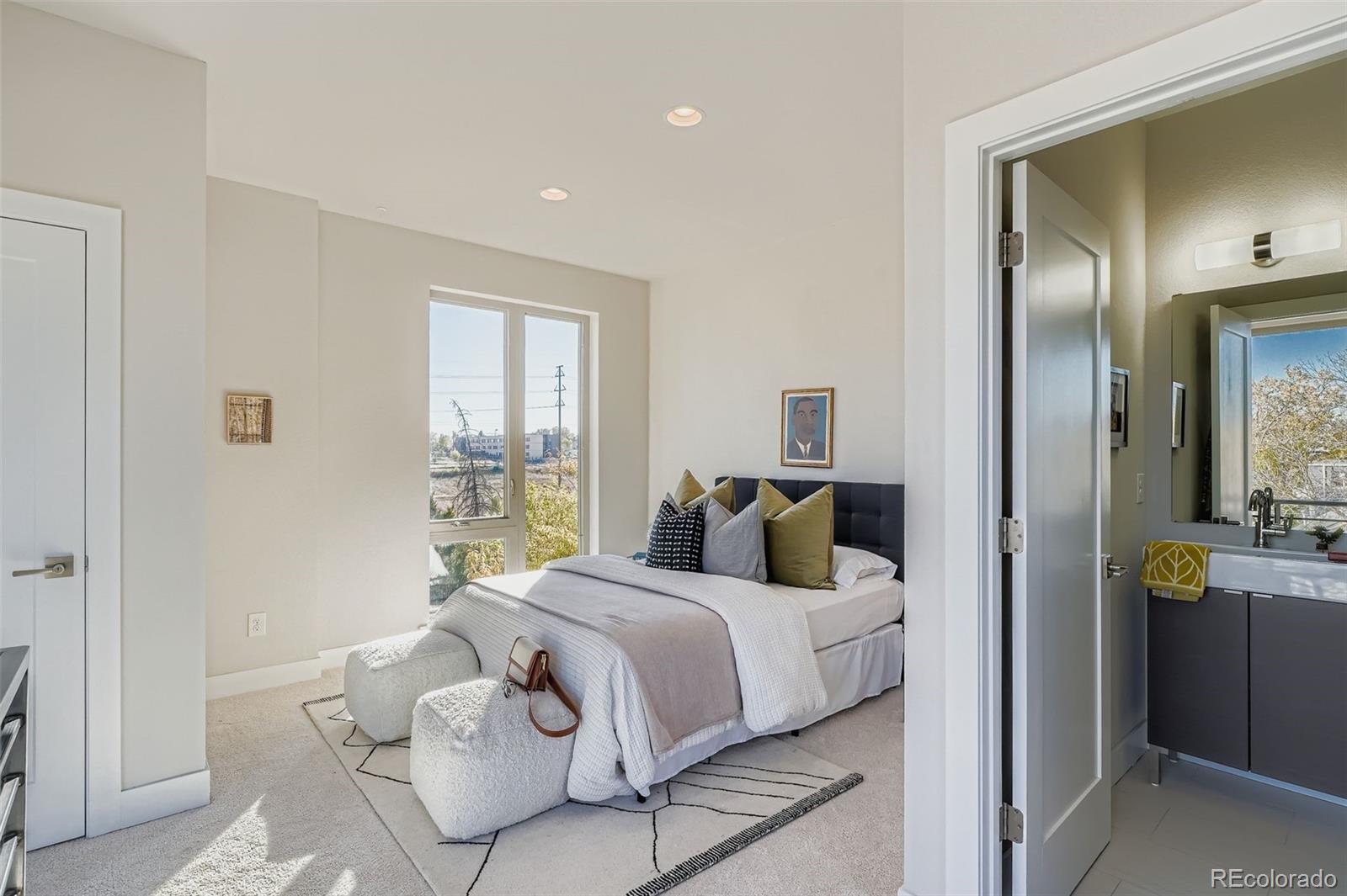 1261 Xavier Street Denver, CO 80204 - Photo 15 of 27 a bedroom with a bed and a window