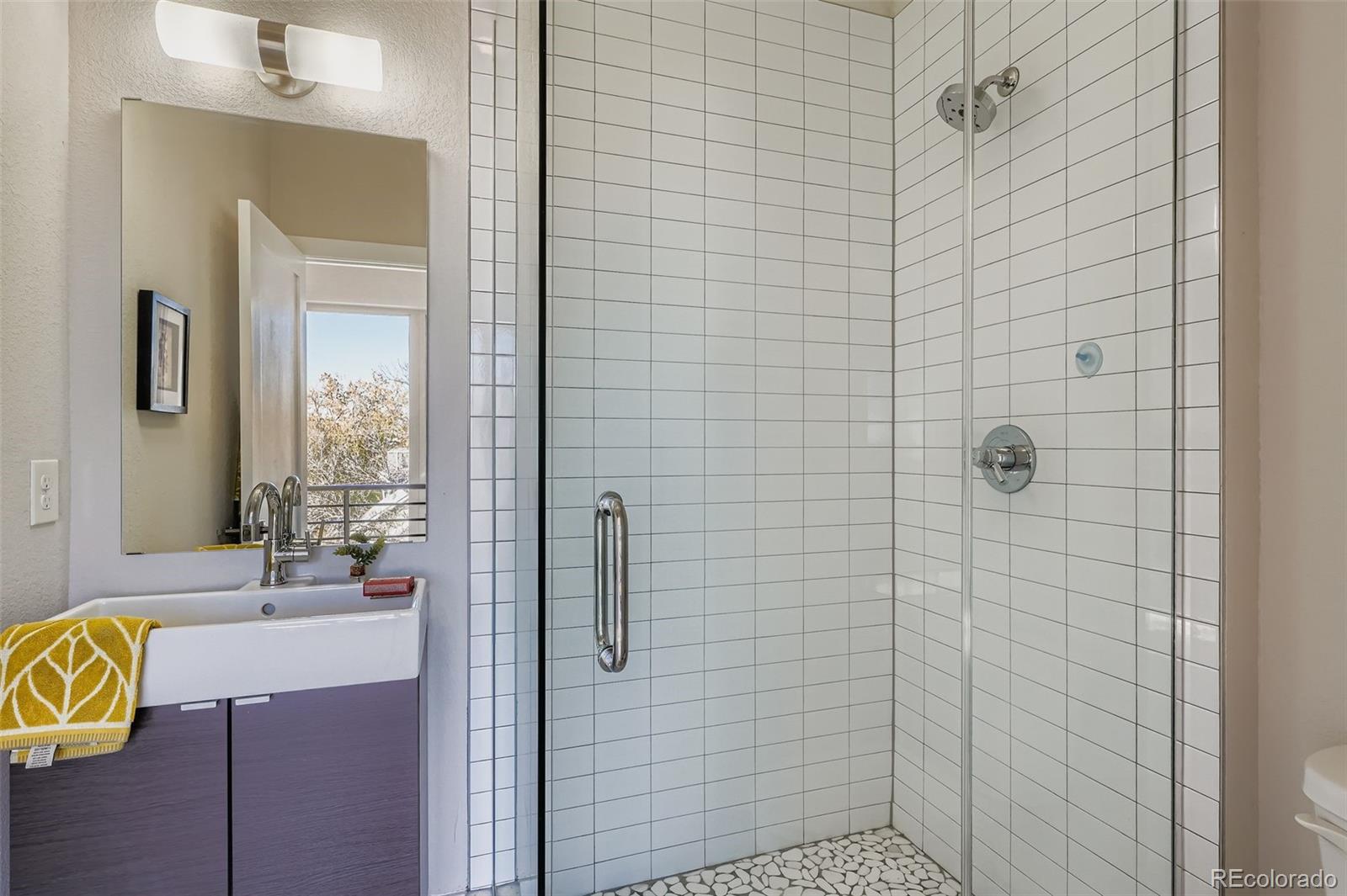 1261 Xavier Street Denver, CO 80204 - Photo 17 of 27 a bathroom with a shower