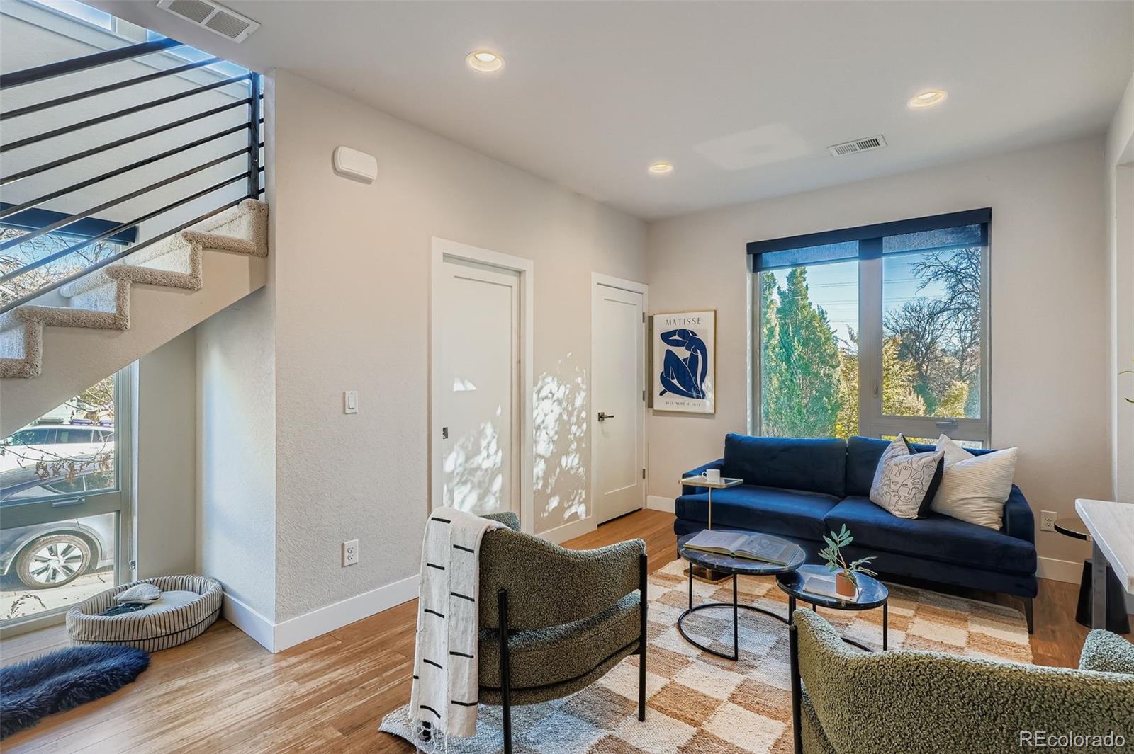 1261 Xavier Street Denver, CO 80204 - Photo 3 of 27 a living room with furniture and a window