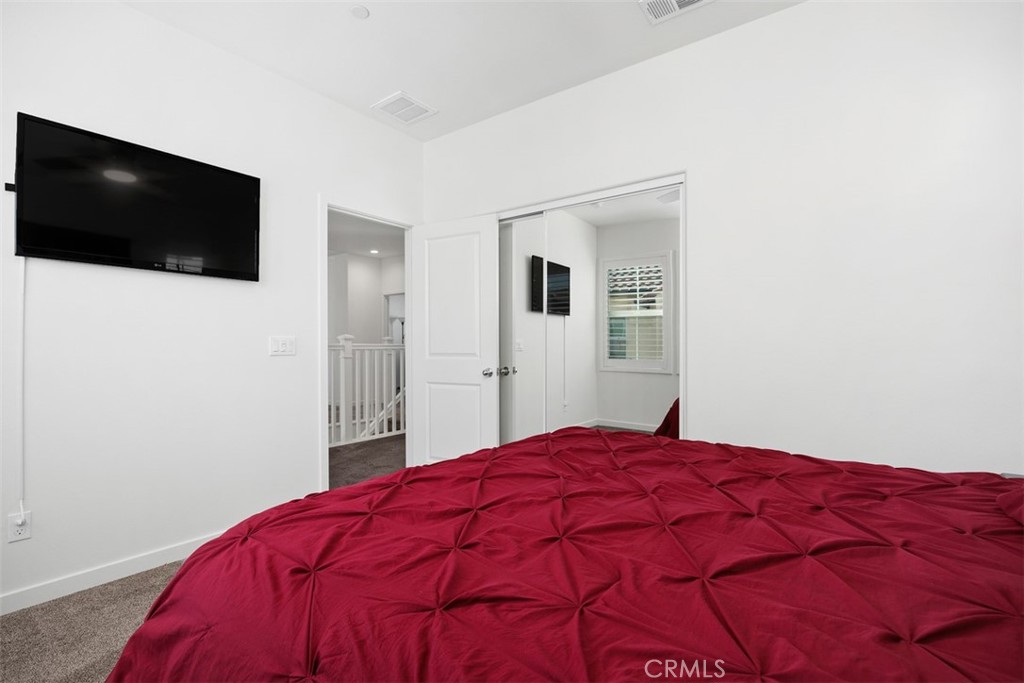 4130 Via Del Rey Oceanside, CA 92057 - Photo 18 of 35 a bedroom with a bed and a flat screen tv