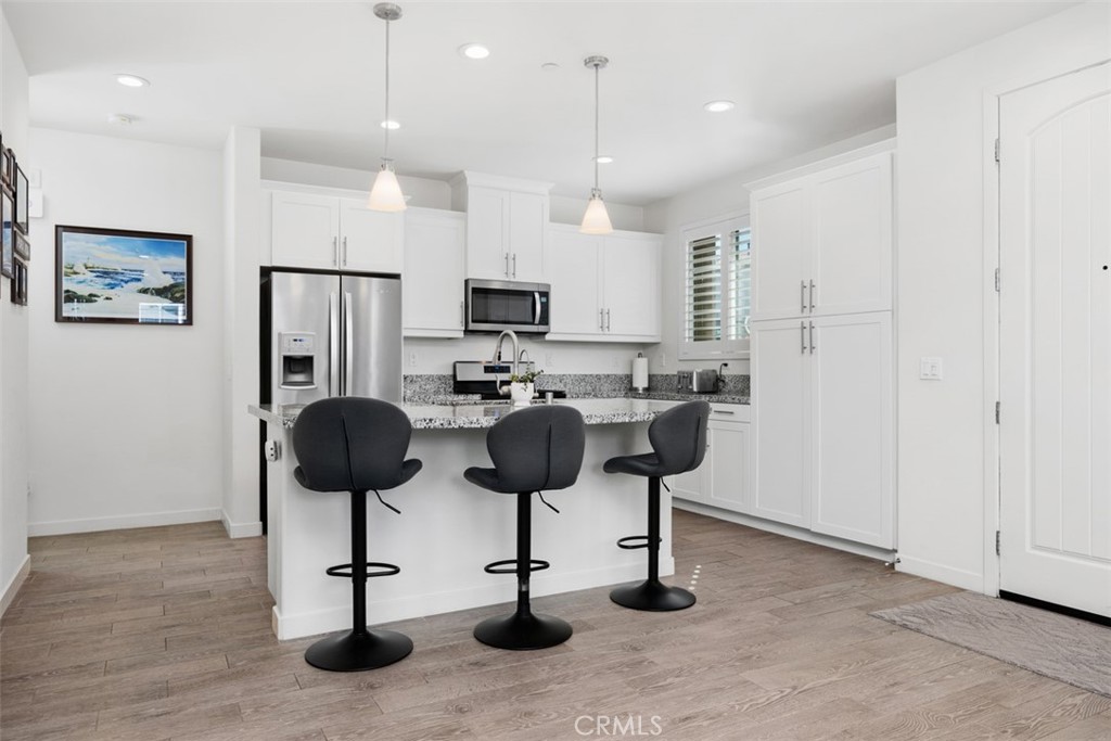 4130 Via Del Rey Oceanside, CA 92057 - Photo 5 of 35 a kitchen with stainless steel appliances kitchen island a refrigerator and a stove