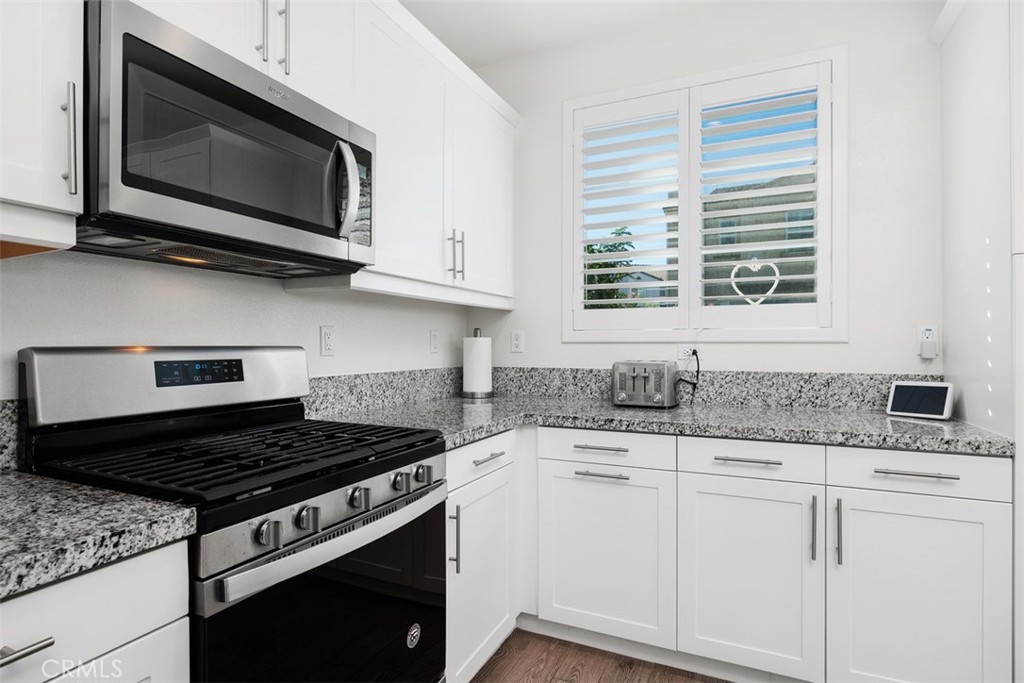 4130 Via Del Rey Oceanside, CA 92057 - Photo 7 of 35 a kitchen with granite countertop cabinets stainless steel appliances and a sink