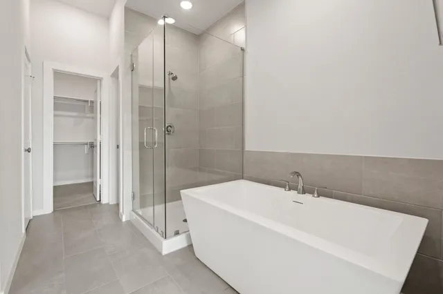 a bathroom with a bathtub and a shower
