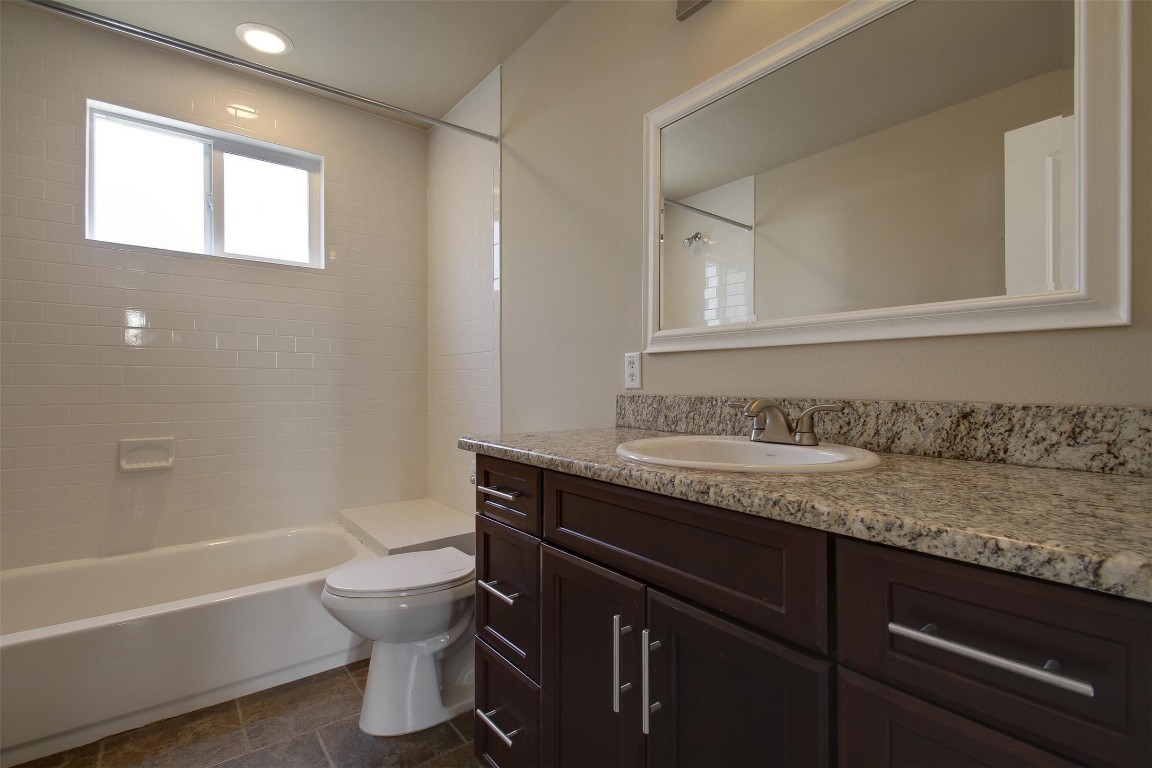4509 Depew Avenue Austin, TX 78751 - Photo 9 of 32 a bathroom with a granite countertop toilet sink and bathtub