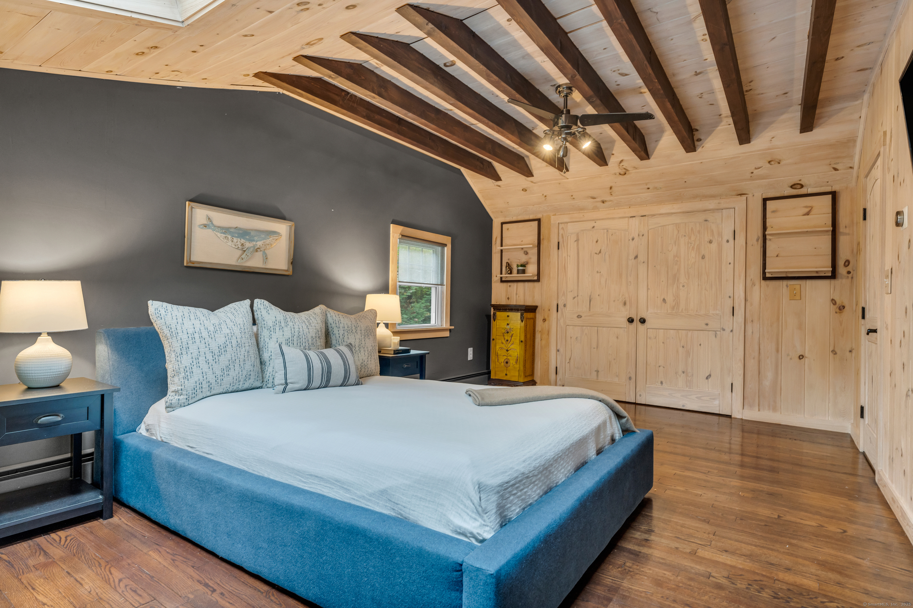 735 Opening Hill Road Madison, CT 06443 - Photo 18 of 39 a spacious bedroom with a bed and a wooden floor