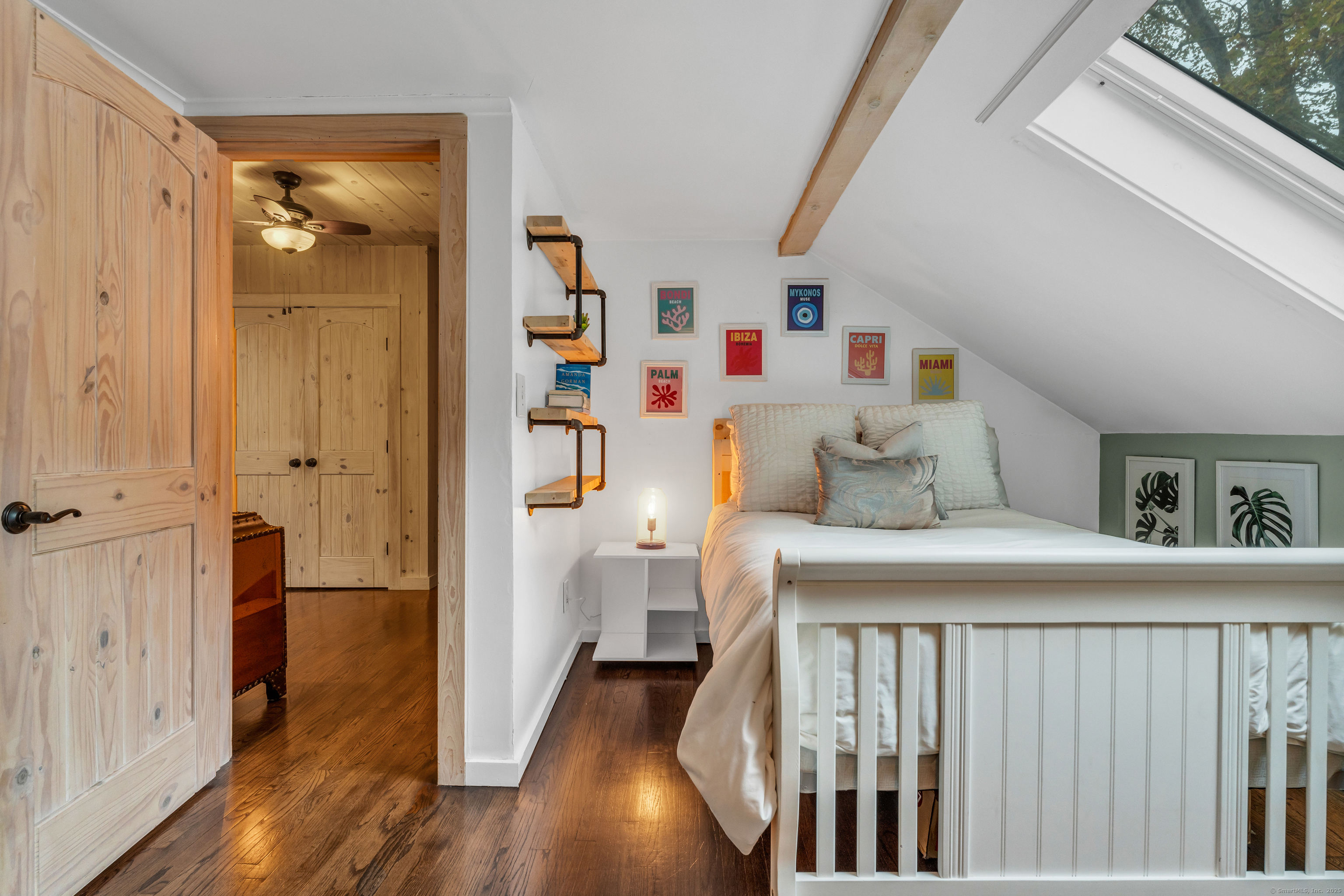 735 Opening Hill Road Madison, CT 06443 - Photo 19 of 39 a bedroom with a bed and wooden floor