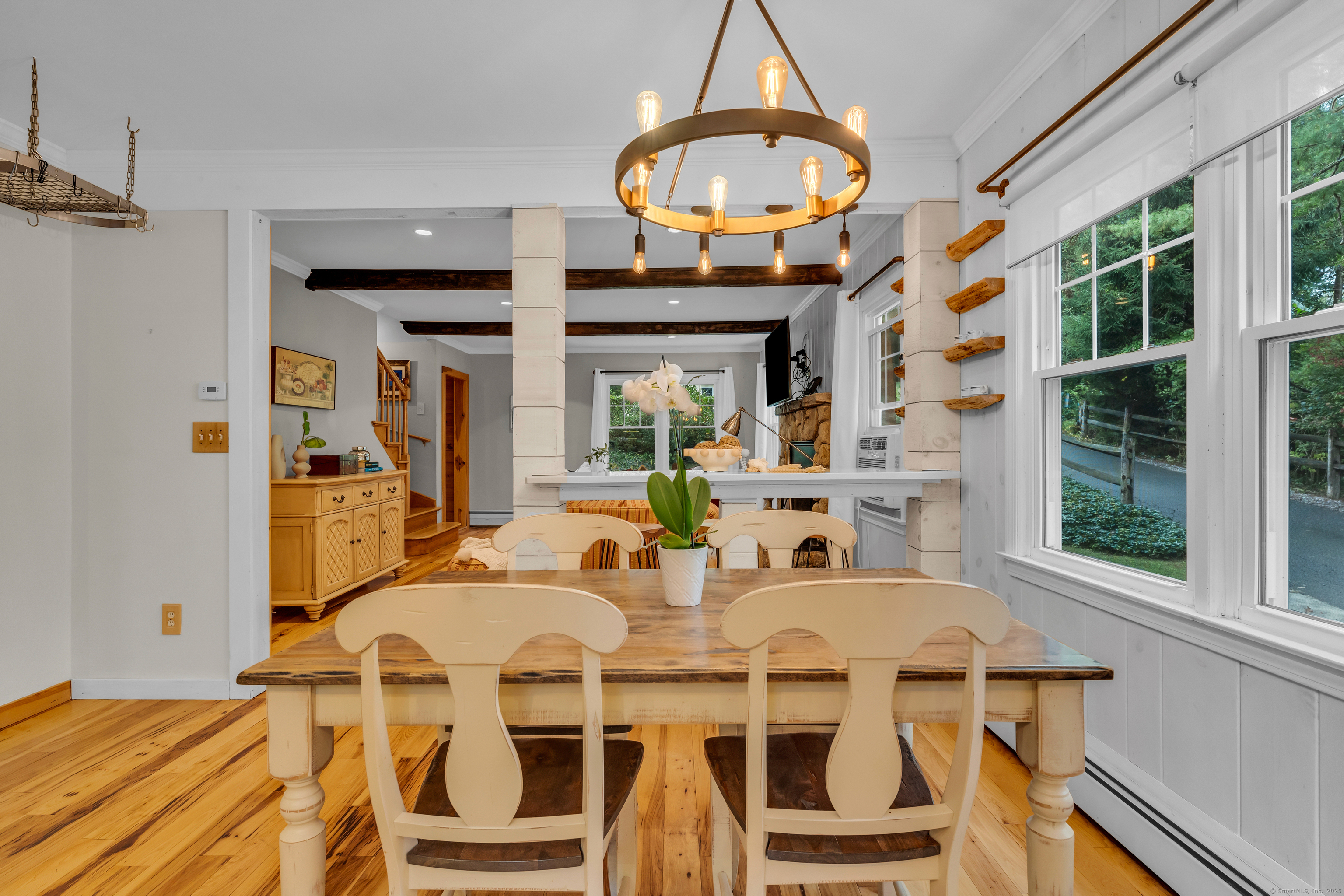 735 Opening Hill Road Madison, CT 06443 - Photo 7 of 39 a view of a dining room with furniture a chandelier and wooden floor