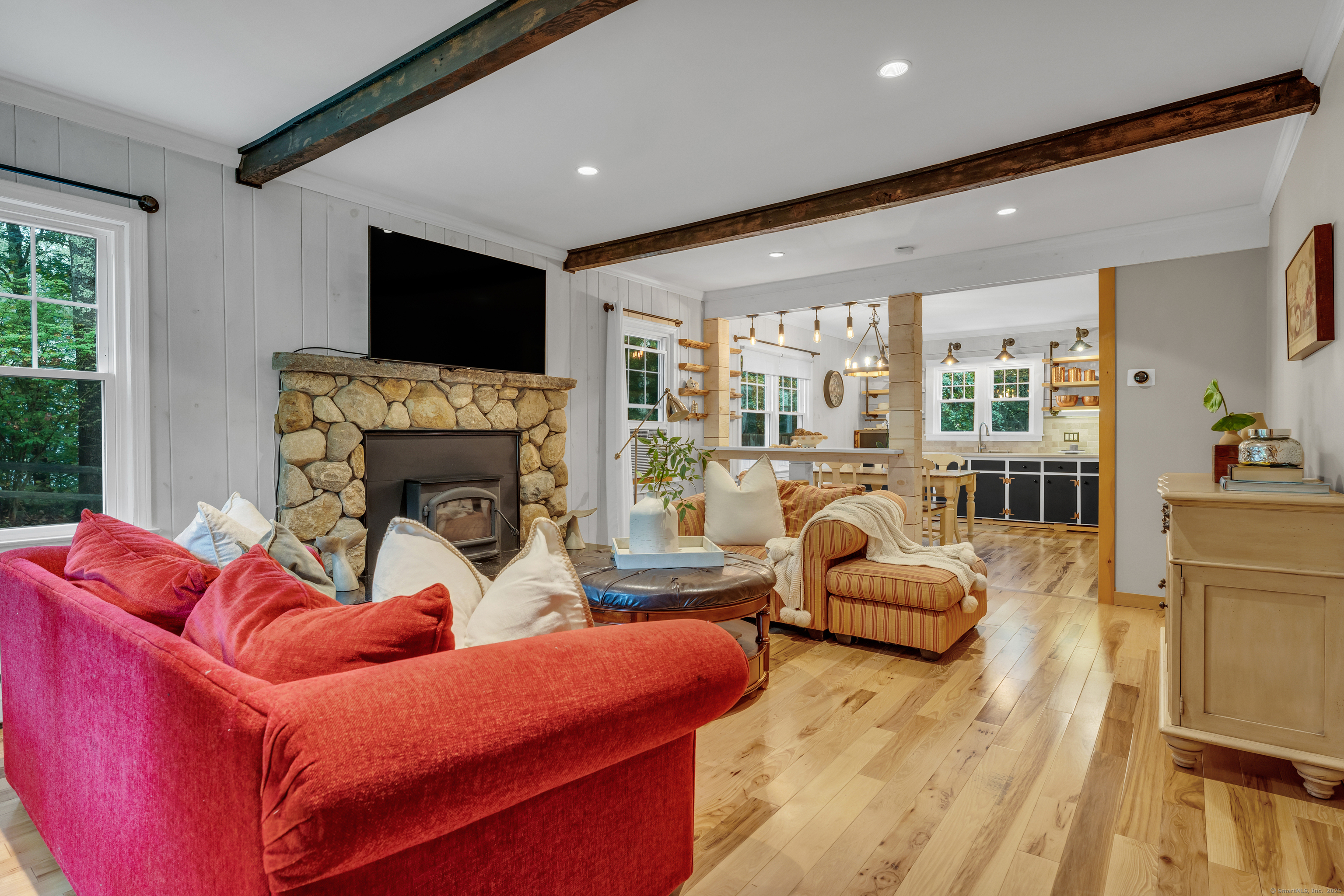 735 Opening Hill Road Madison, CT 06443 - Photo 9 of 39 a living room with furniture fireplace and flat screen tv