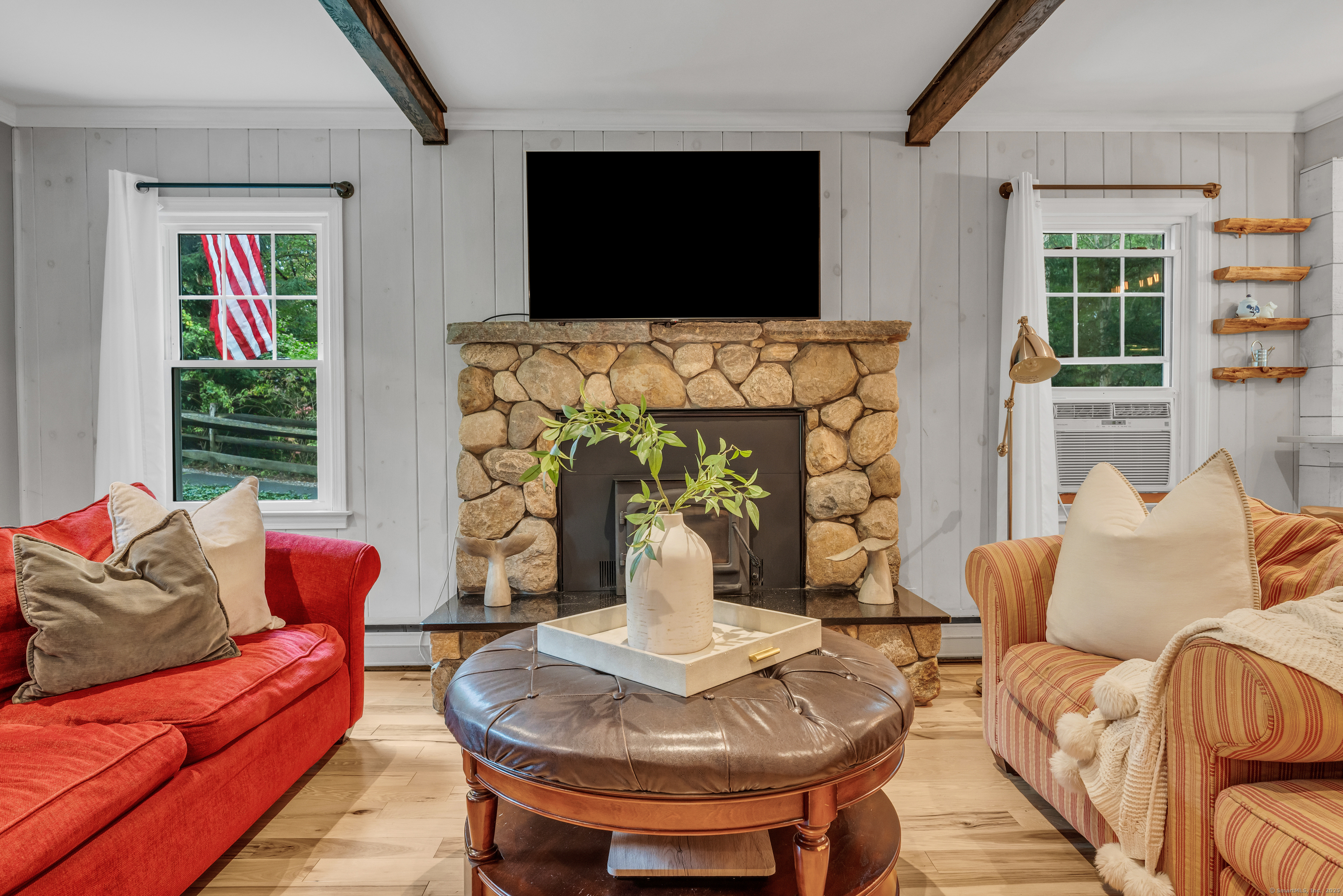 735 Opening Hill Road Madison, CT 06443 - Photo 10 of 39 a living room with fireplace furniture and a flat screen tv