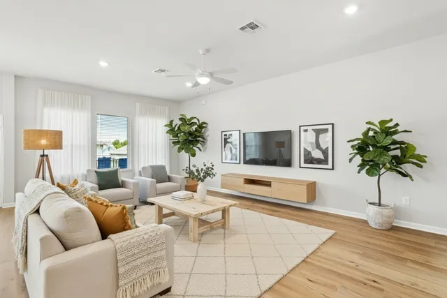 a living room with furniture potted plant and a window