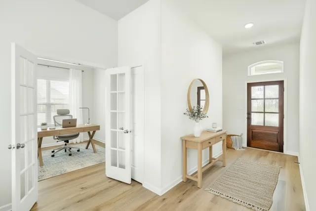 a living room with furniture and wooden floor