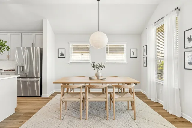 a dining room with furniture and a chandelier