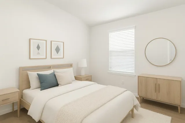 a bedroom with a bed and a window