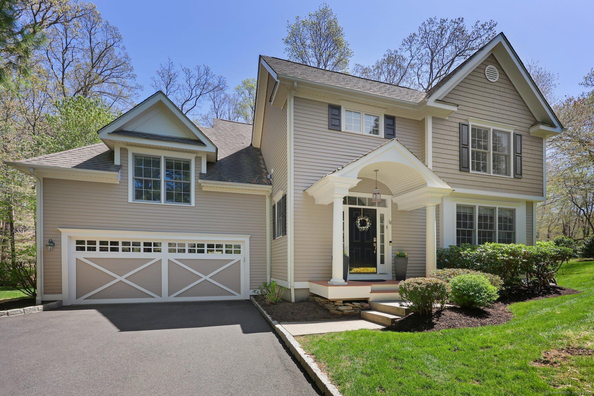 12 Woods Way, Unit 12 Redding, CT 06896 - Photo 1 of 1 a front view of a house with a yard and garage