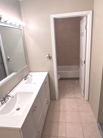 a view of a room with wooden floor and a window