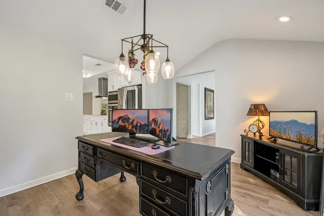 a view of a dining room with furniture and a chandelier