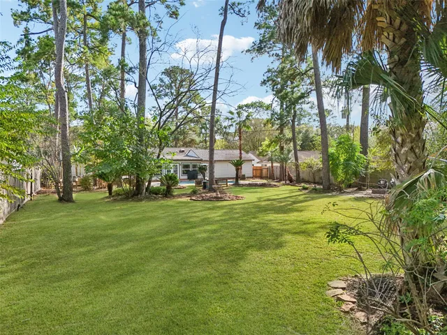 a view of backyard with swimming pool