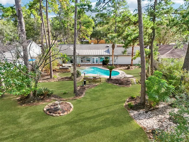 a view of a backyard with lawn chairs and a fire pit