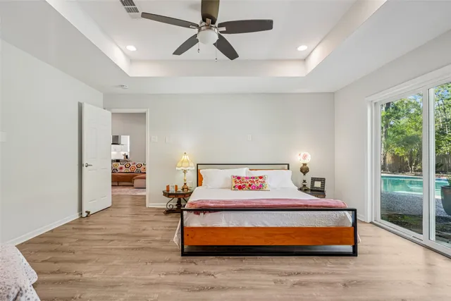 a bedroom with a bed and wooden floor