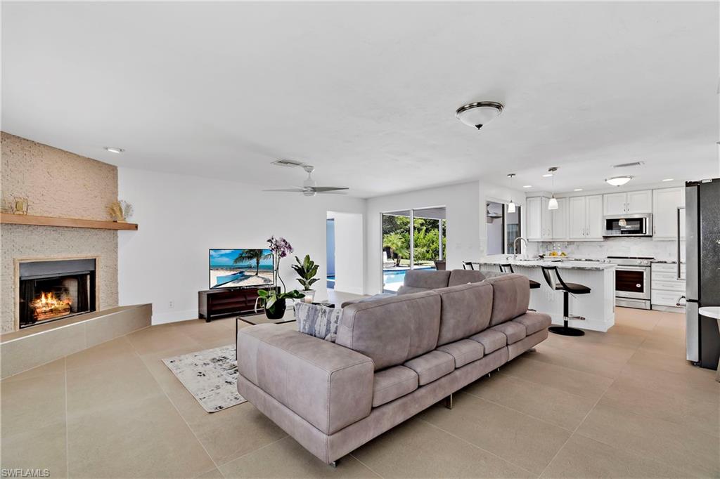 740 Orchid Drive Naples, FL 34102 - Photo 13 of 33 a living room with furniture and a fireplace