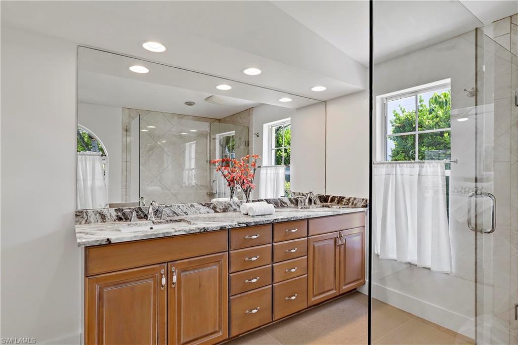 740 Orchid Drive Naples, FL 34102 - Photo 19 of 33 a bathroom with a granite countertop sink mirror and double