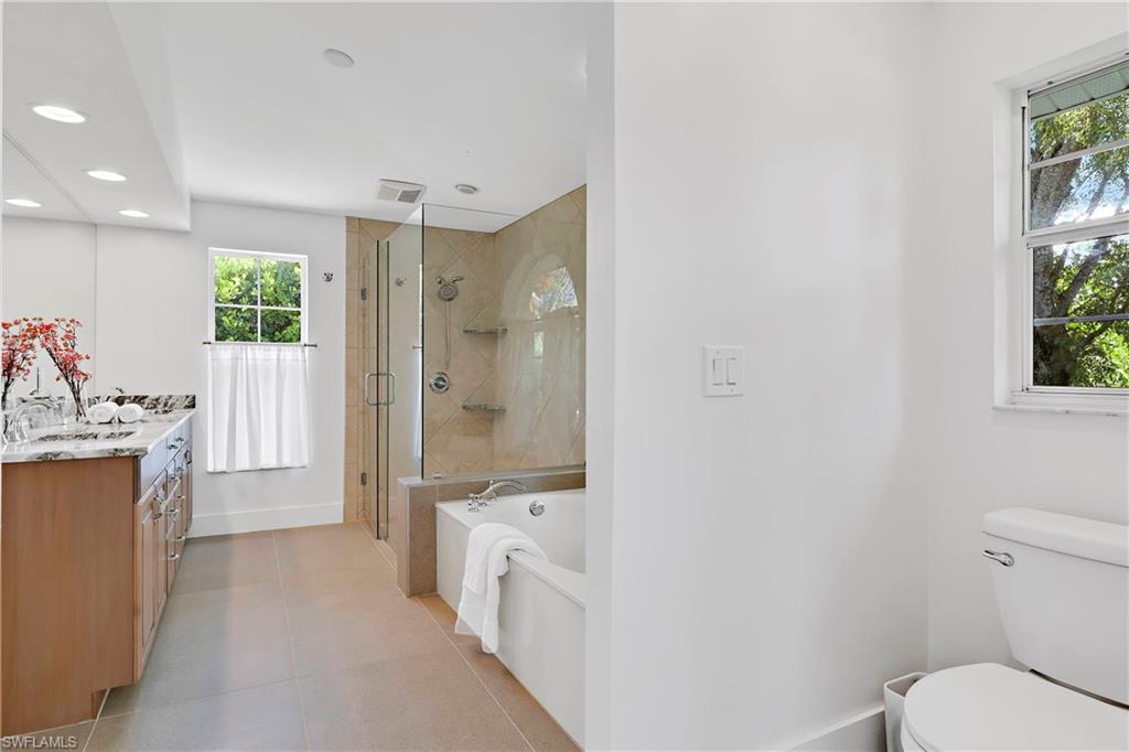 740 Orchid Drive Naples, FL 34102 - Photo 20 of 33 a bathroom with a sink a toilet and shower
