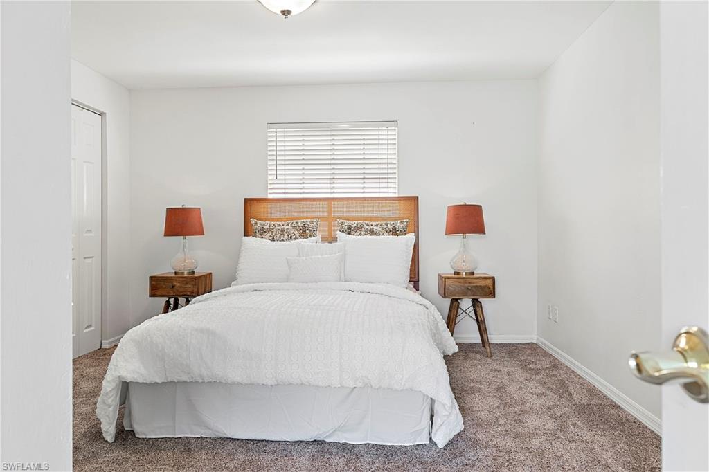 740 Orchid Drive Naples, FL 34102 - Photo 22 of 33 a bedroom with a bed and window