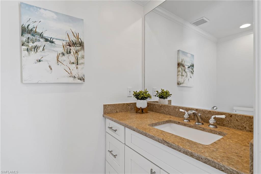 740 Orchid Drive Naples, FL 34102 - Photo 24 of 33 a bathroom with a granite countertop sink and a mirror