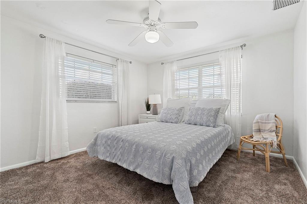 740 Orchid Drive Naples, FL 34102 - Photo 29 of 33 a bedroom with a bed and window
