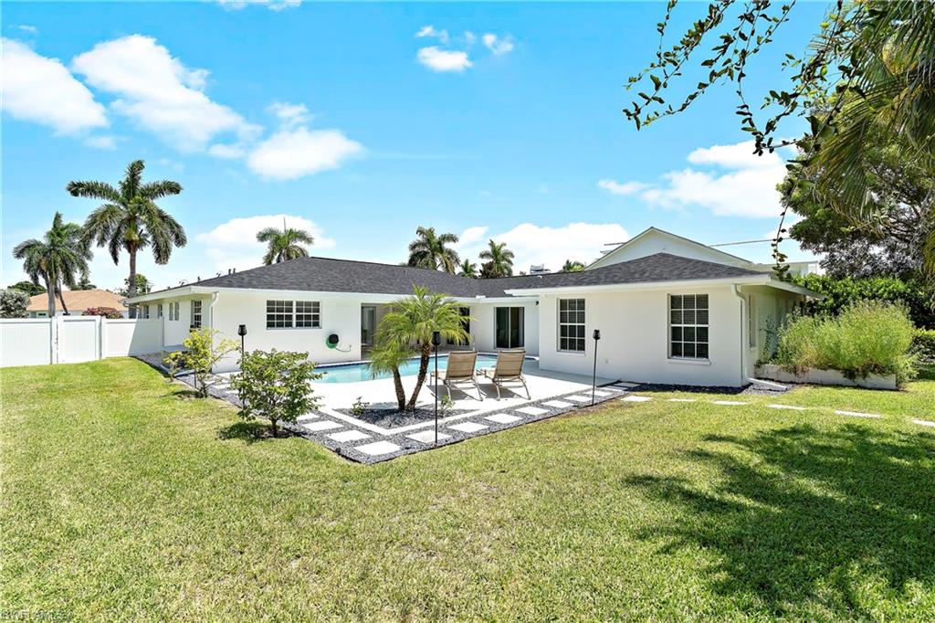 740 Orchid Drive Naples, FL 34102 - Photo 3 of 33 a view of a house with backyard and sitting area