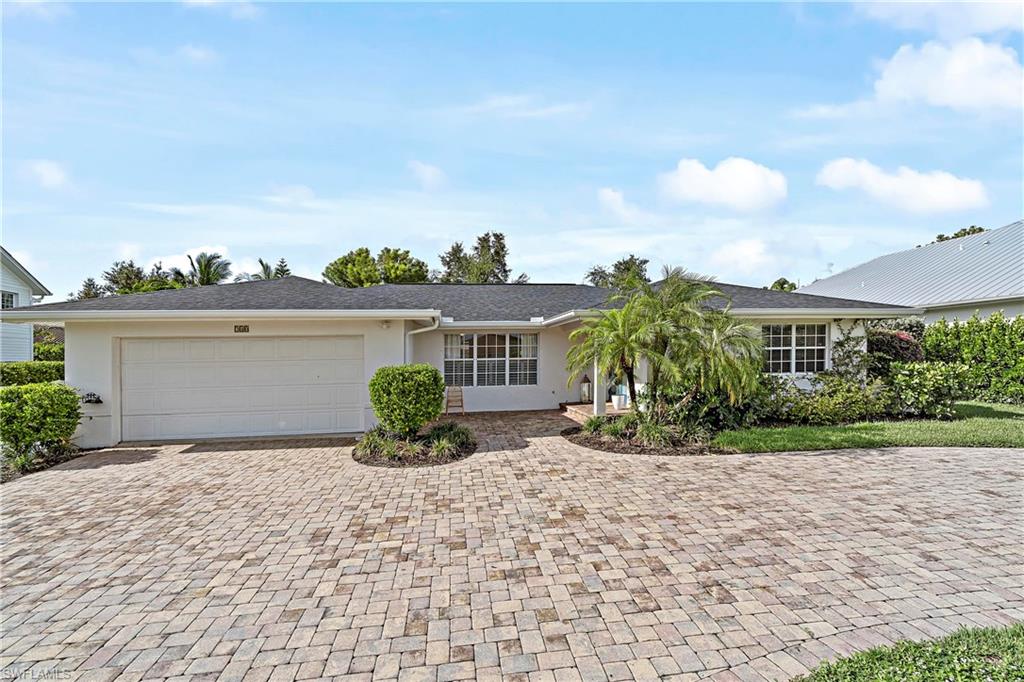 740 Orchid Drive Naples, FL 34102 - Photo 31 of 33 front view of a house with a yard