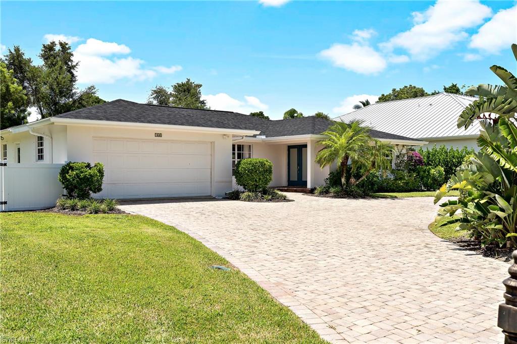 740 Orchid Drive Naples, FL 34102 - Photo 33 of 33 a front view of a house with a yard
