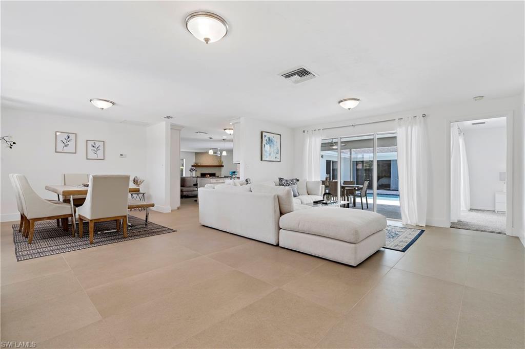 740 Orchid Drive Naples, FL 34102 - Photo 7 of 33 a living room with furniture and a large window