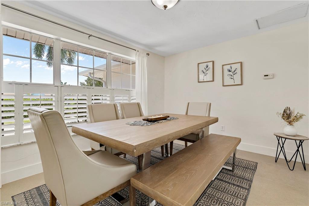 740 Orchid Drive Naples, FL 34102 - Photo 9 of 33 a view of a dining room with furniture window and wooden floor