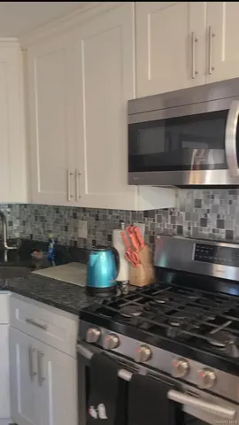 a stove top oven sitting inside of a kitchen