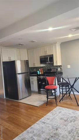 a kitchen with stainless steel appliances granite countertop a refrigerator stove top oven a sink and dishwasher